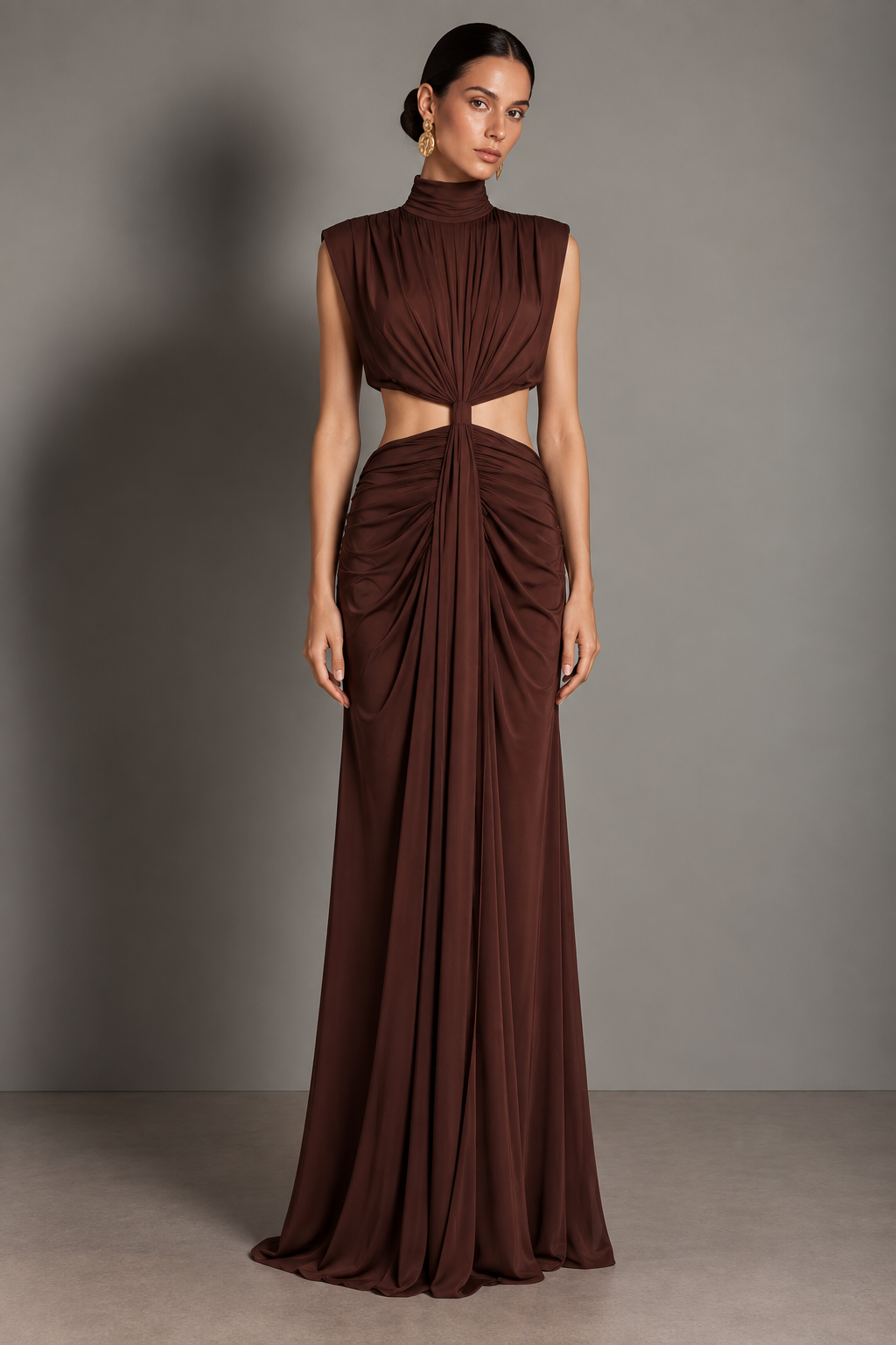 Chocolate-brown column gown with a bare-midriff waist cutout and center-front draping from neck to hem.