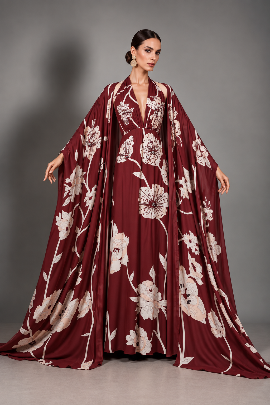 Burgundy and ivory floral print gown, the same print as Camélia, with dramatic full-length open cape sleeves and a deep-V cut-out-shoulder halter.