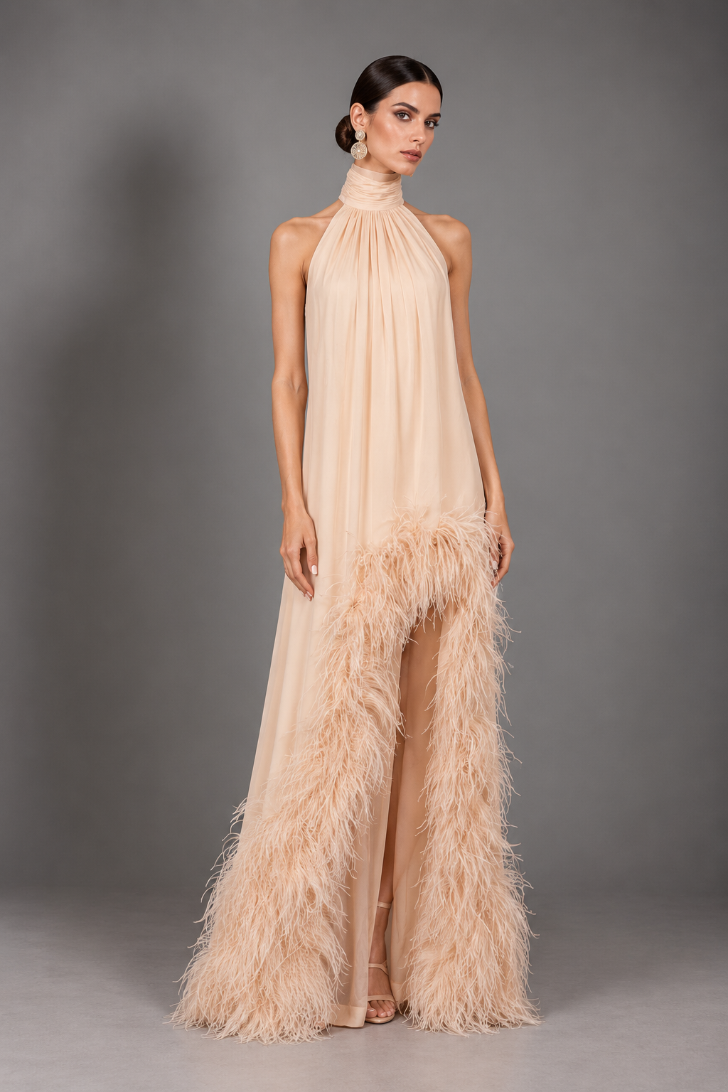 Pale champagne halter dress with a loose, unfitted body, a center front slit, and a dense feather-trimmed hem.